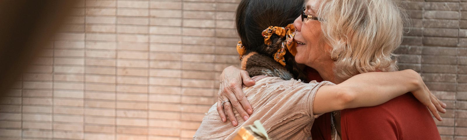 An Elderly Woman Hugging a Person Giving Thanks