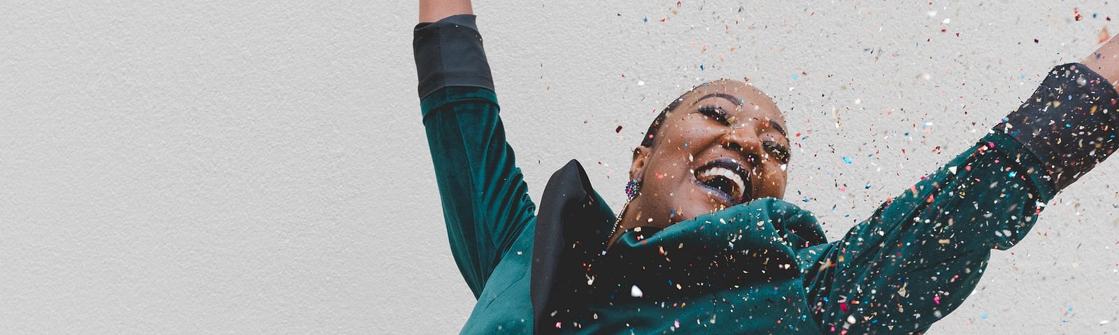 woman jumping for joy with confetti