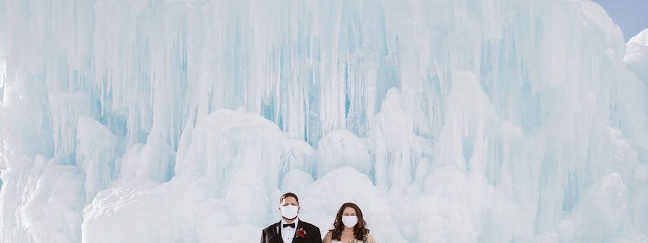 Individuals in front of a glacier.