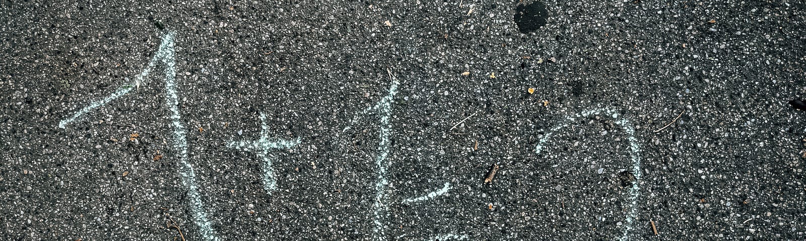A simple math equation — 1 + 1 = 2 — is written on the ground by a child.