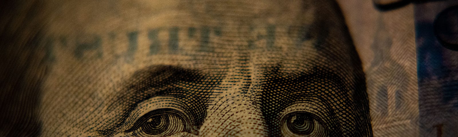 A closeup of a US hundred dollar bill (Benjamin Franklin side).