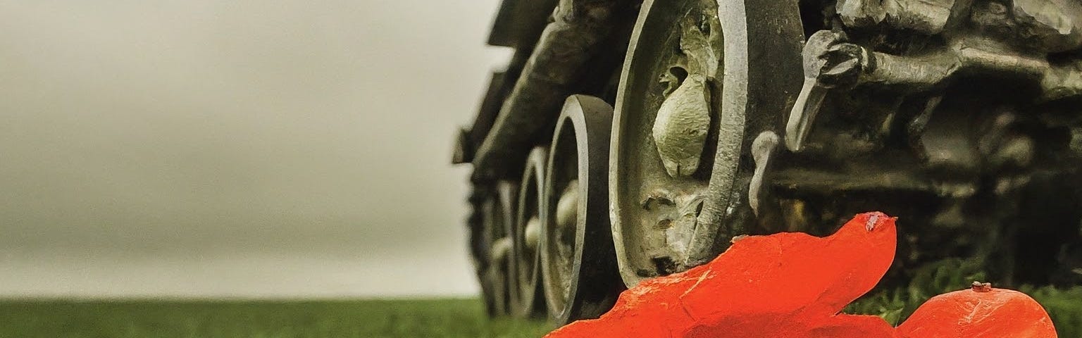 “A red poppy crushed underneath a tank tread, in a green field under a grey-white smoky sky” (Image generated by the author using ImageFX)