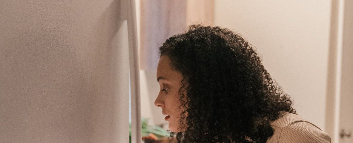 Woman reaching inside an opened refrigerator.
 Photo by Mike Jones on Pexels