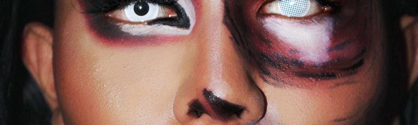 Closeup photo of spooky face paint and altered eyes