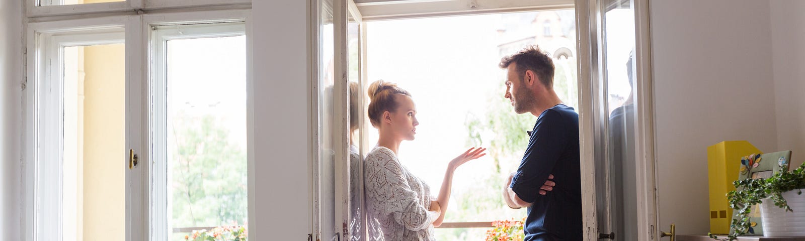 Young couple arguing in doorway