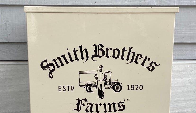 metal milk box on a porch with the Smith Brothers Farms logo
