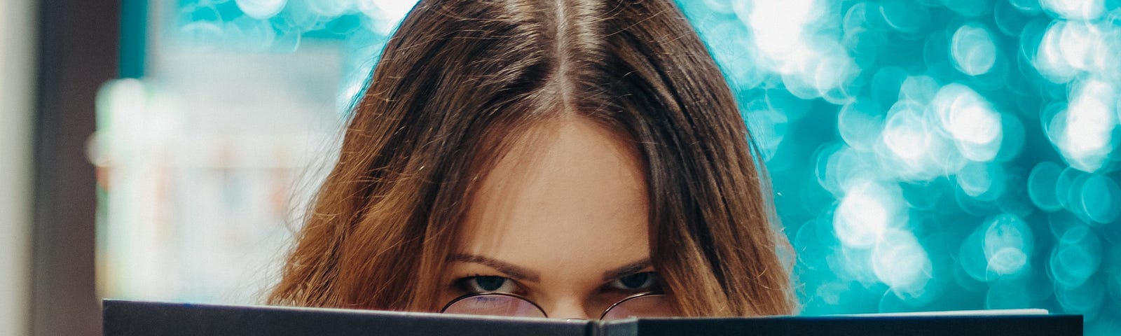 Woman looking annoyed, reading book titled, “ID.”