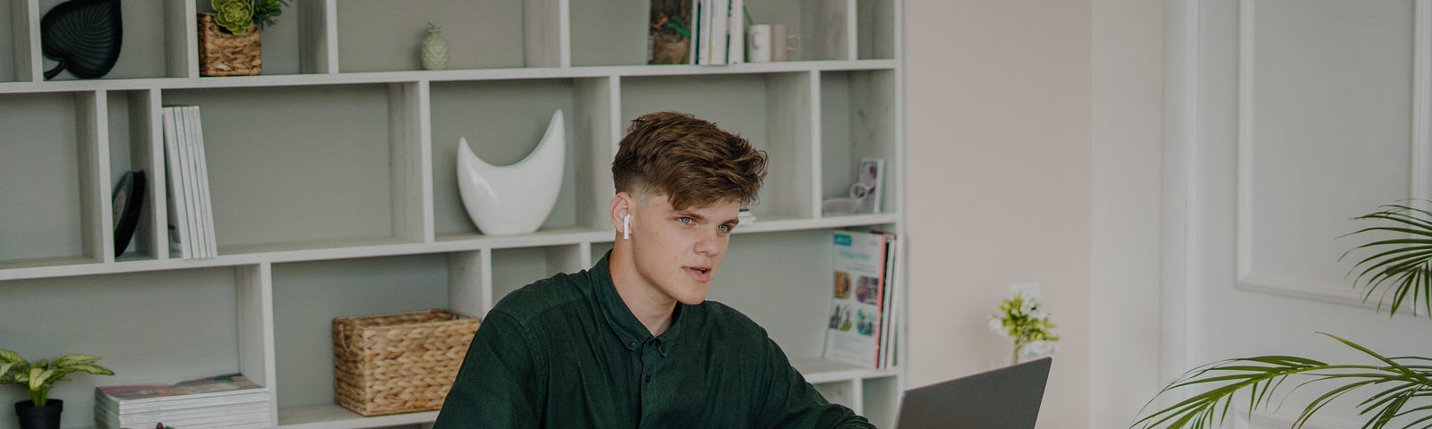 Man with airpods working at his desk
