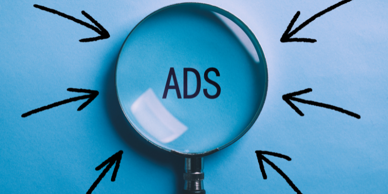 Magnifying glass with the words “ADS” in the middle — How I Boosted My AdSense Earnings By >500%