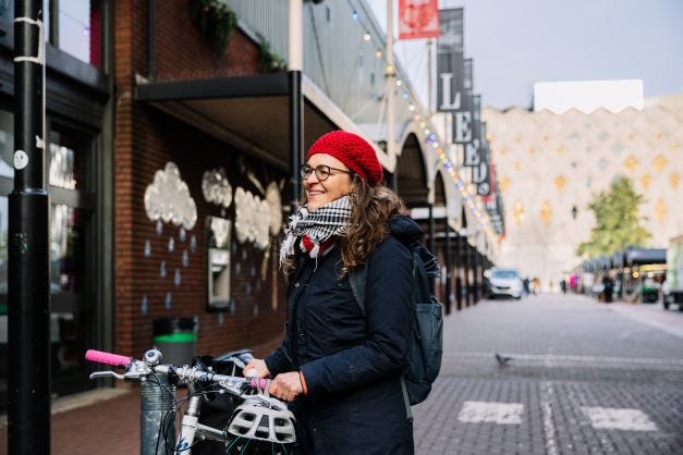 Professor Sara González parks her bike outside Kirkgate Market in Leeds City Centre.