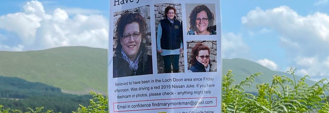 Picture of a poster attached to a post, reading “Have you seen Mary” and featuring pictures of a woman with brown hair and glasses, a picture of her car, and an appeal for information.