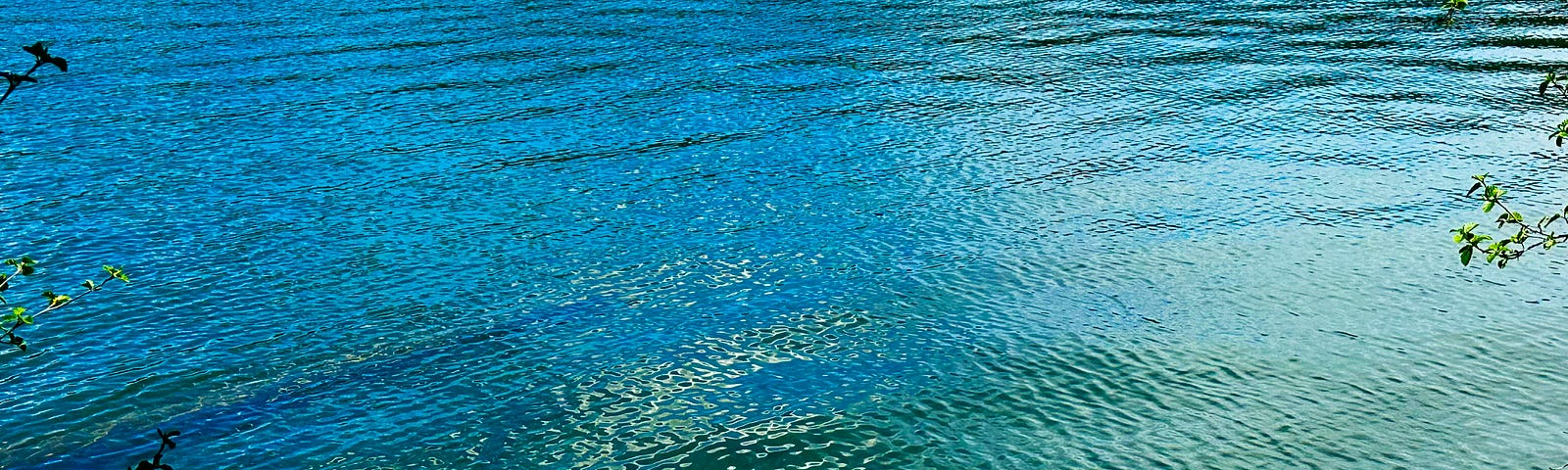 Ripples on the surface of a blue-green lake.