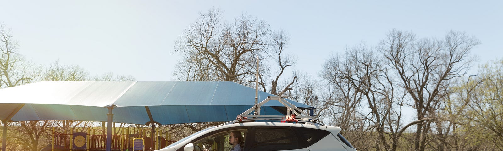 UT Austin researcher drives an SUV equipped with a state-of-the-art air sampling device through a park in eastern Travis County.