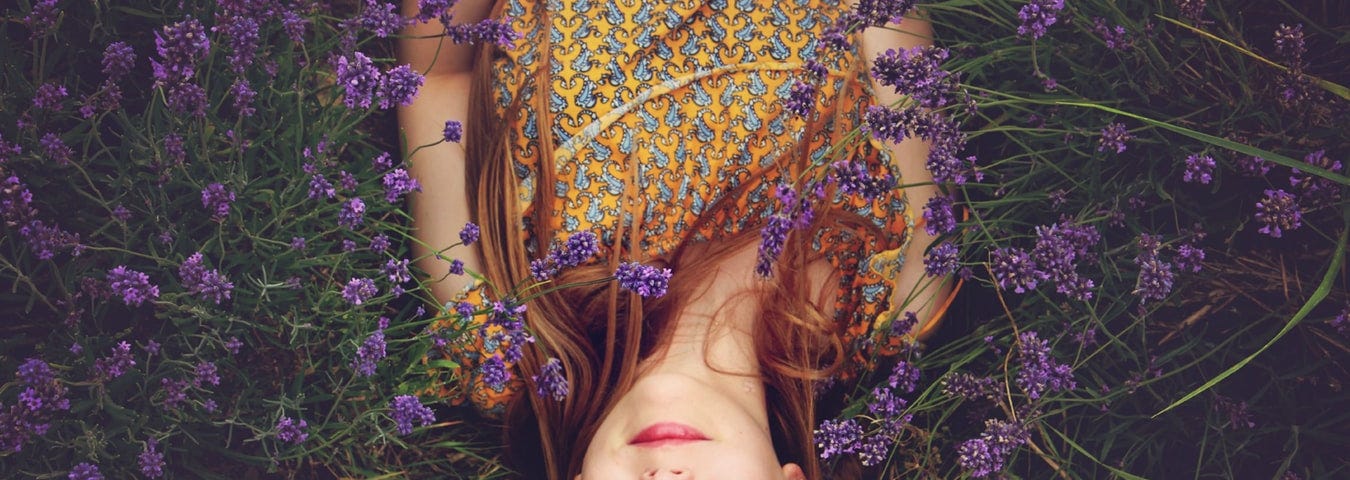 woman lying in purple flowers