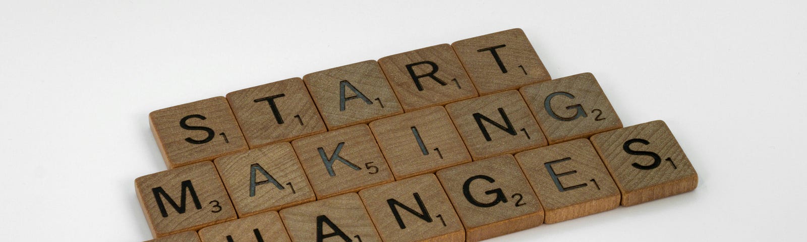Scrabble tiles spell “Start Making Changes”.