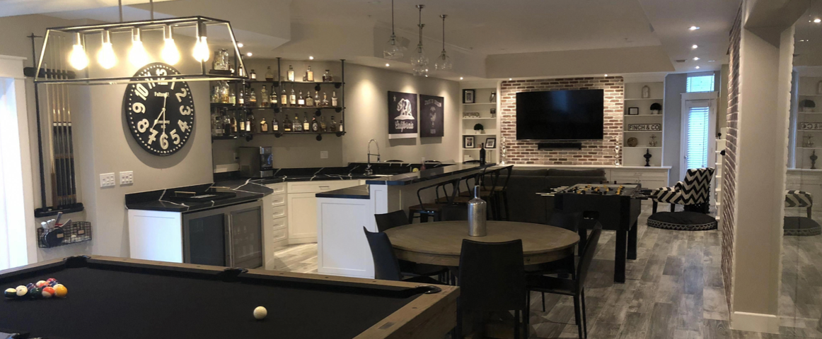 picture of a man cave with pool table, chairs and tv