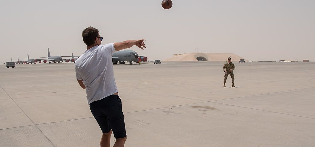 Tom Brady throwing a football.