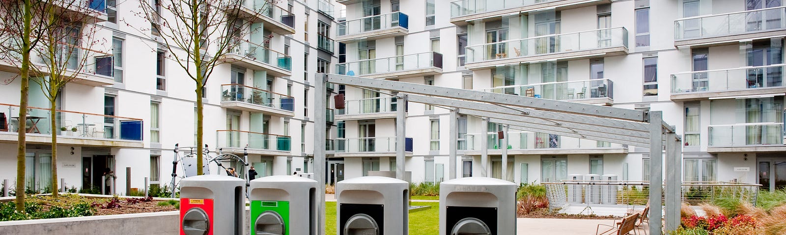 A photograph shows four waste chutes in a courtyard of Wembley Park, which has an underground vacuum waste system.