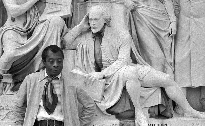 James Baldwin standing near a statue of Shakespeare Albert Memorial from Allan Warren