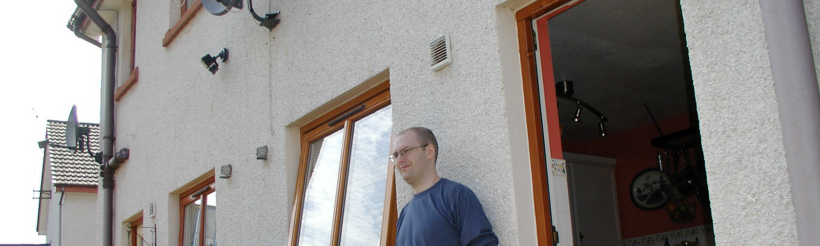 Brian Duff in summer 2003 standing outside the backdoor of a a semi-detached house in Edinburgh