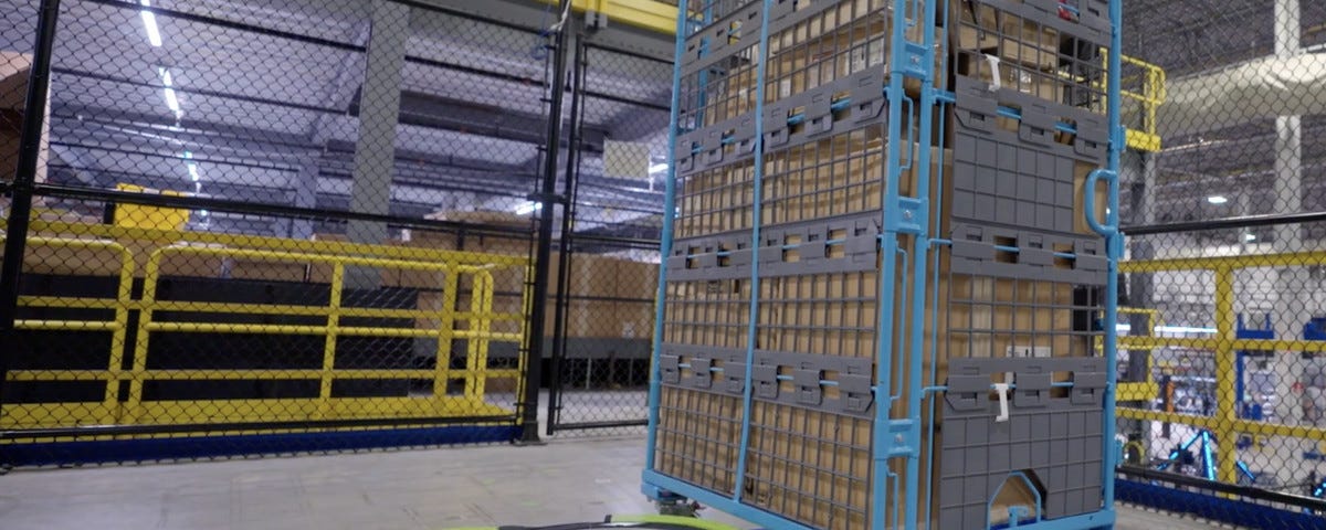 IMAGE: An Amazon Proteus robot moving a shelf with products in an automated warehouse
