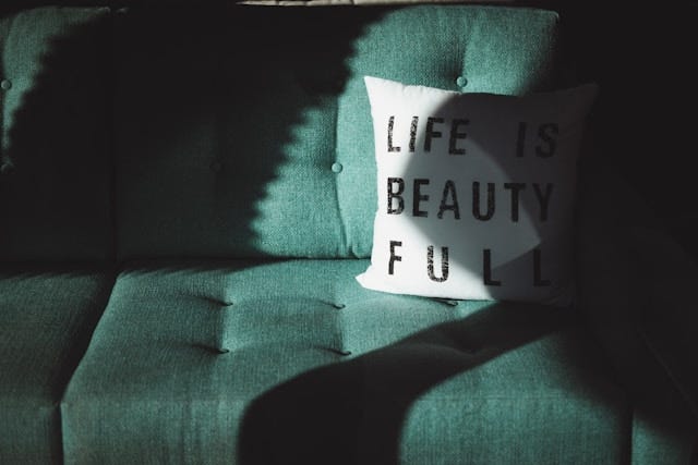 Sofa with pillow that says “Life is beautiful.”