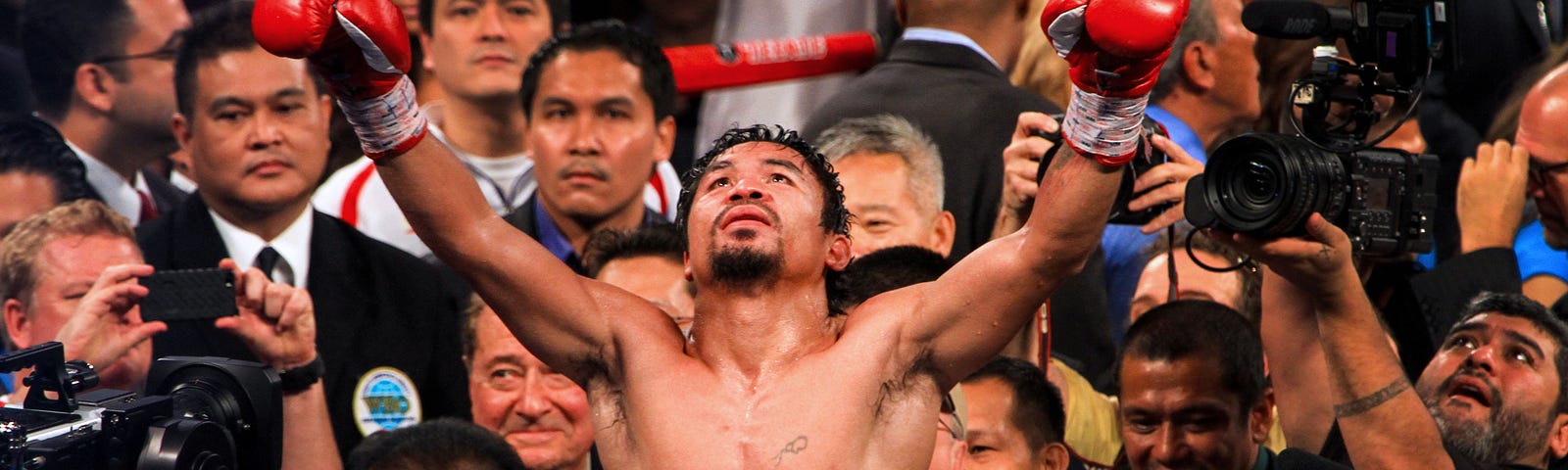 A boxer celebrating after winning the fight between people and media