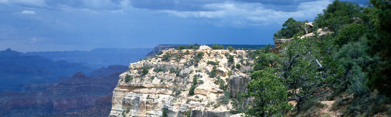 A dramatic view of Mexico’s Copper Canyon, with blue skies and jagged rockfaces, a challenge for climbing!