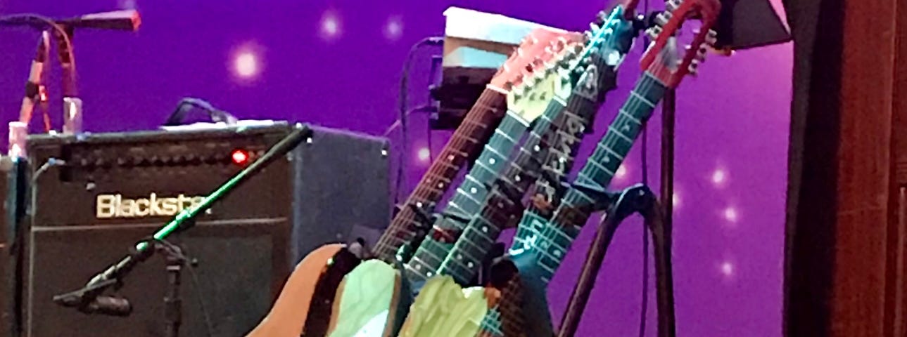 Photo of guitars set up before a concert by Mark Tulin.