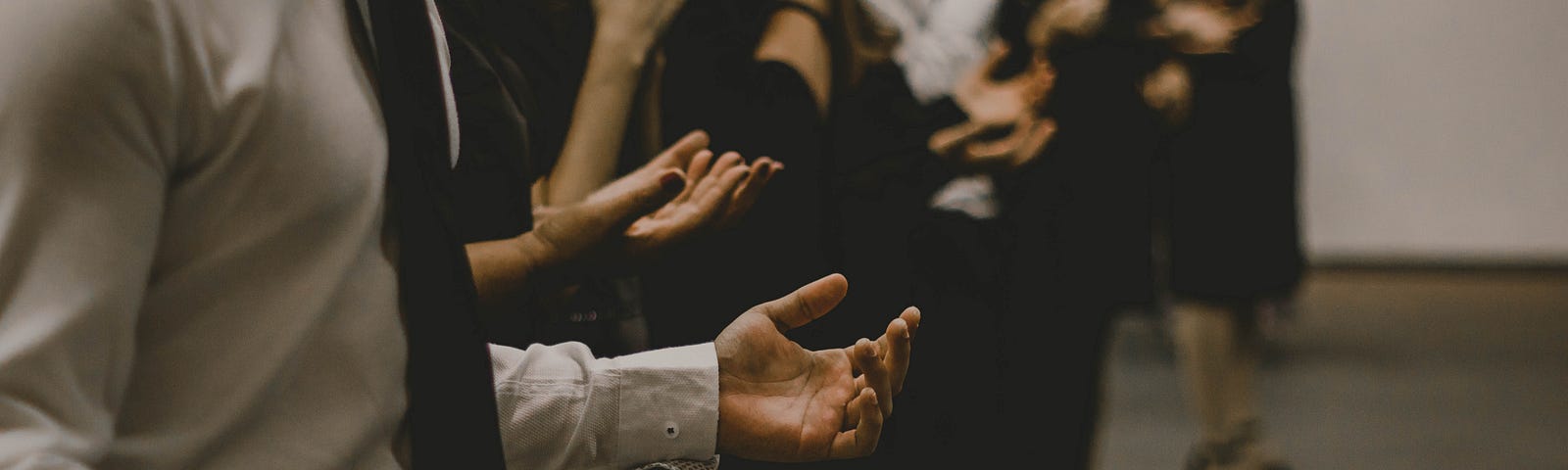 people praying with open hands