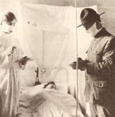 a patient overseen by doctor and nurse at camp Devens in 1918