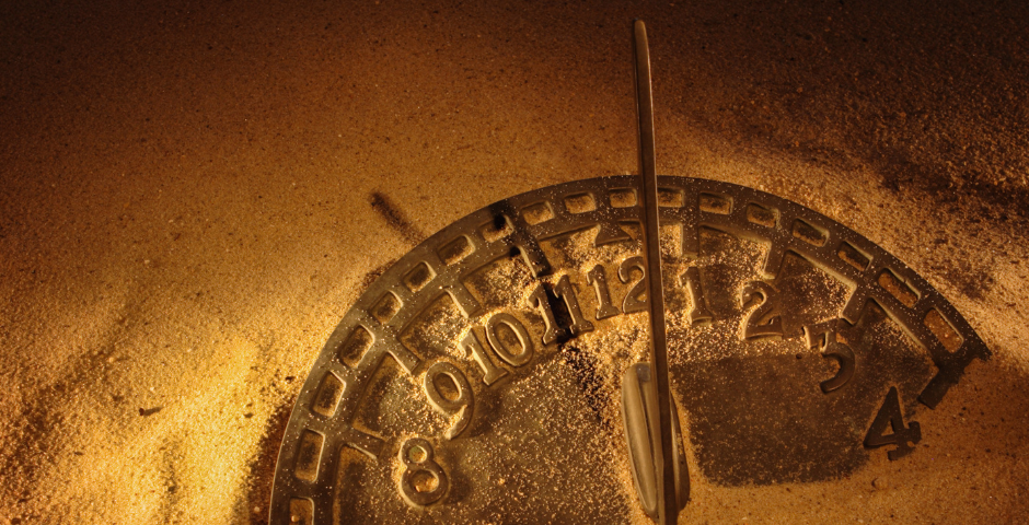 sundial buried in golden sand