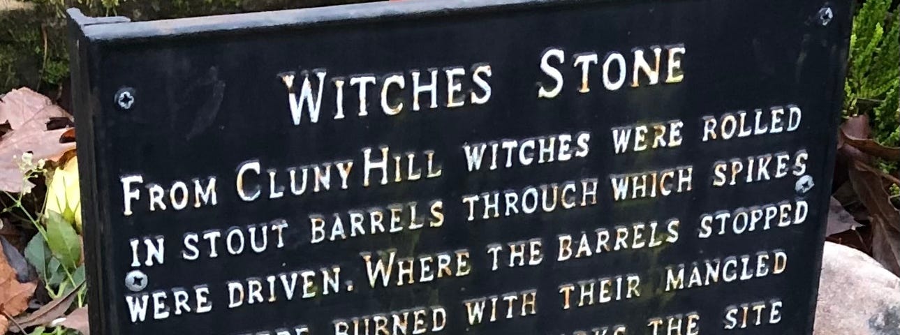 A plaque above the Witches Stone describing the treatment of suspected witches.