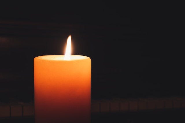 Candle against dark background.