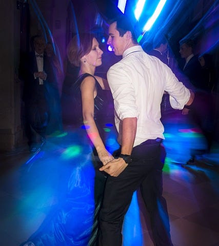 Man & woman dance dancefloor disco, lights, blue dress