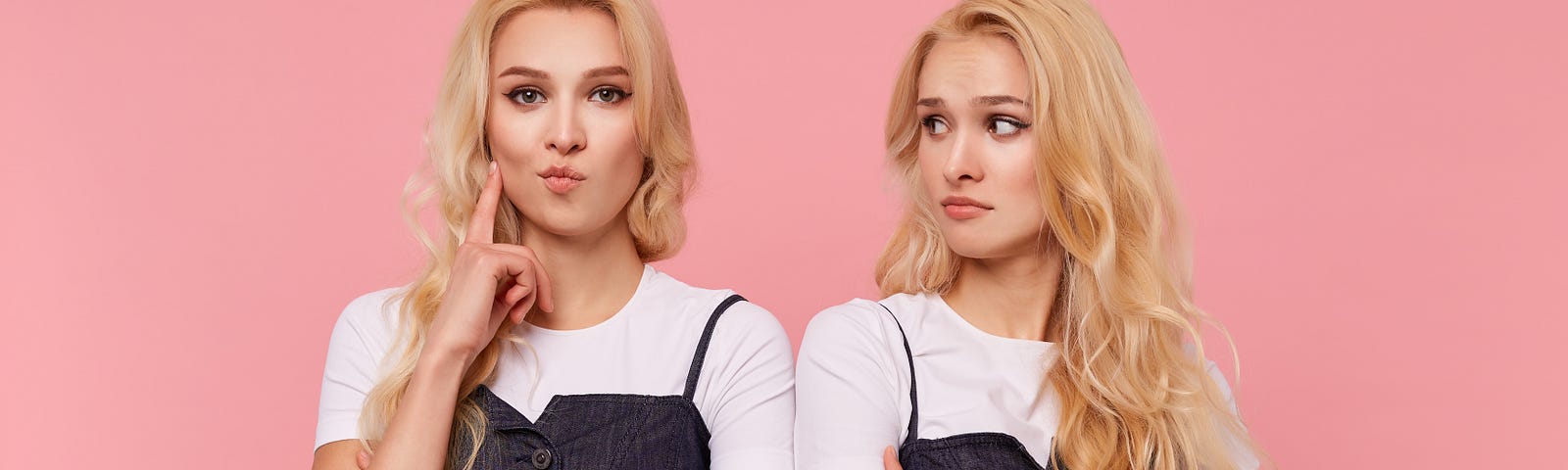 Watch Out, You May Have Two Accounts On Medium. Young brown-eyed long haired female keeping forefinger raised while looking attentively at camera, posing over pink background with her confused pretty blonde sister.
