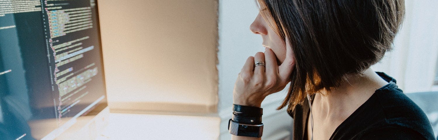 Woman looking at computer monitor.