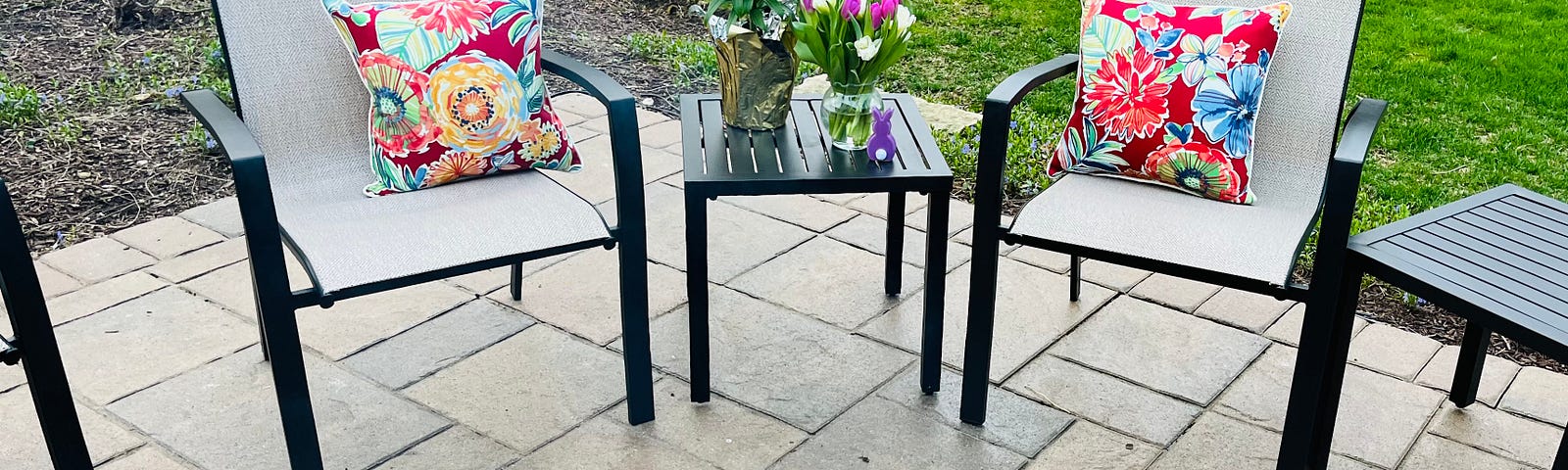 Author patio on Easter, tulips and lilies displayed before a firepit.