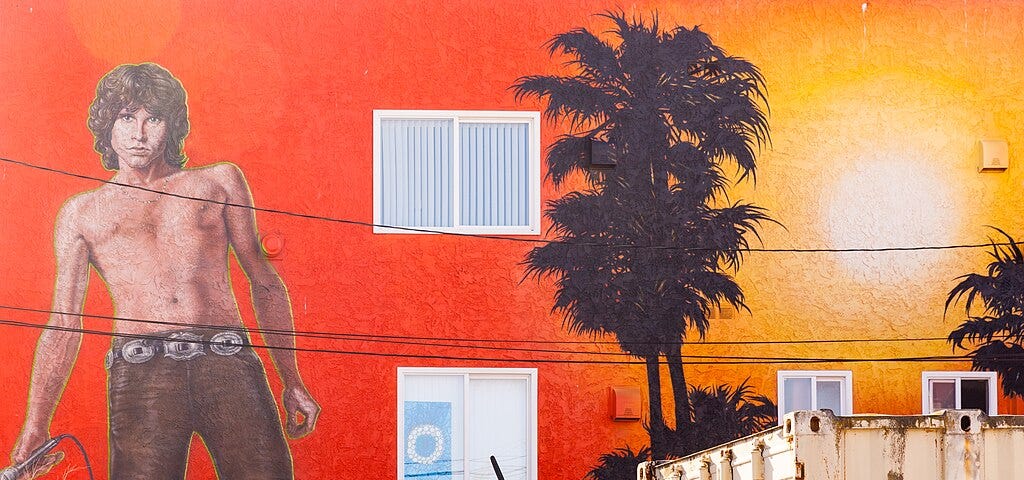Wall mural of a shirtless Jim Morrison from the Doors with a sunset and palm trees