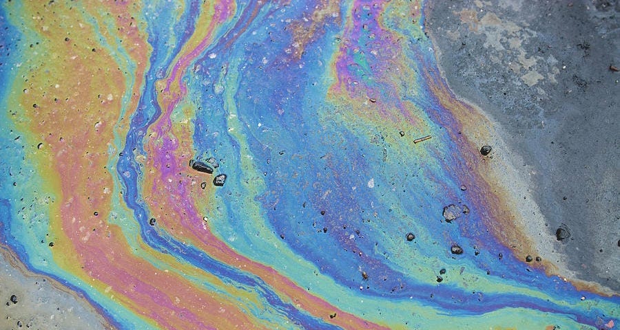 Photograph of an oil slick, by msrphoto via Unsplash