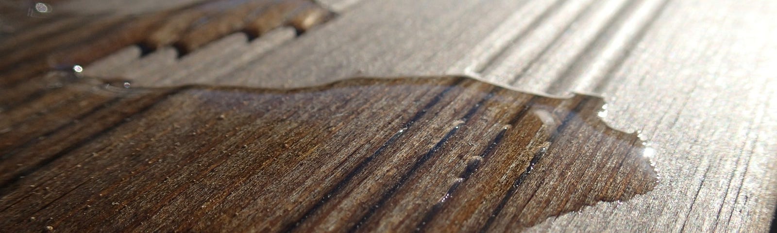 “Water” spilt over some nice polished floorboards.