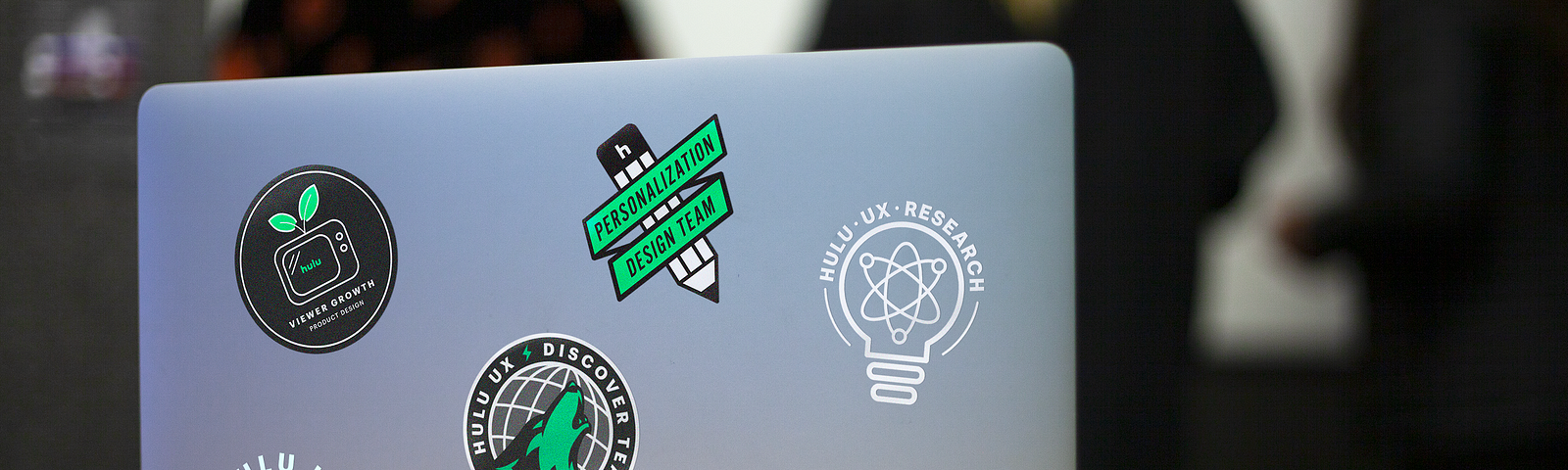 A laptop with the design team stickers