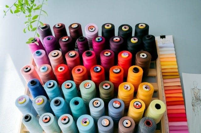 Multi-colored spools of sewing thread