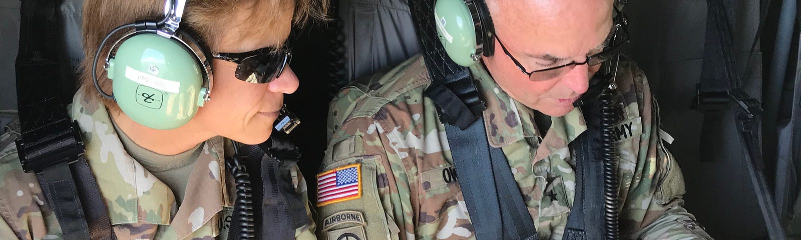 Two Army soldiers (including the author) in a helicopter reviewing maps as they fly over flooded parts of South Carolina following Hurricane Florence in 2018.