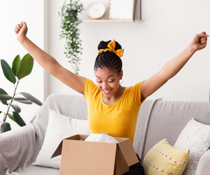 Happy woman opening a gift