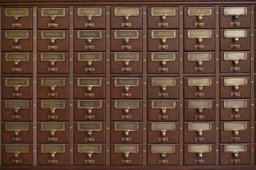 an antique wooden card file from a library. Medium table of contents