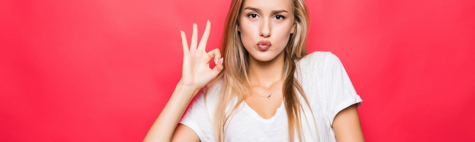 close-up-portrait-happy-girl-gesturing-ok-sign-isolated-red-background — Un Swede