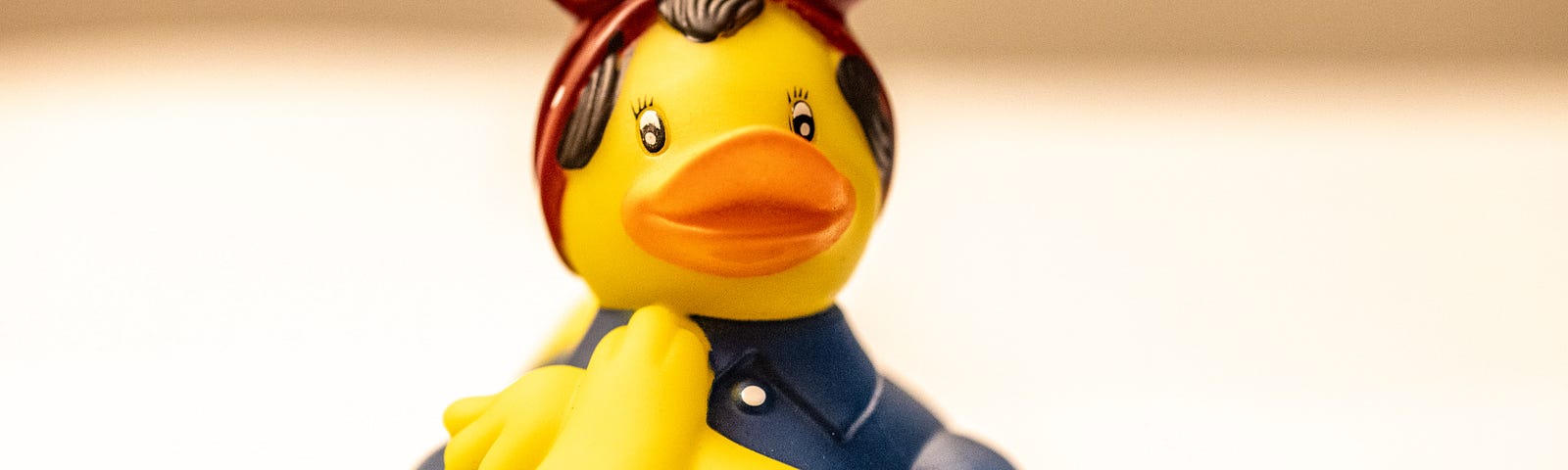 A rubber ducky that looks like Rosie the Riveter.