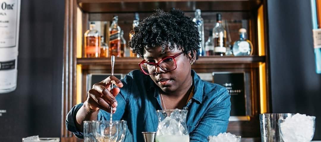 A bartender mixing drinks.