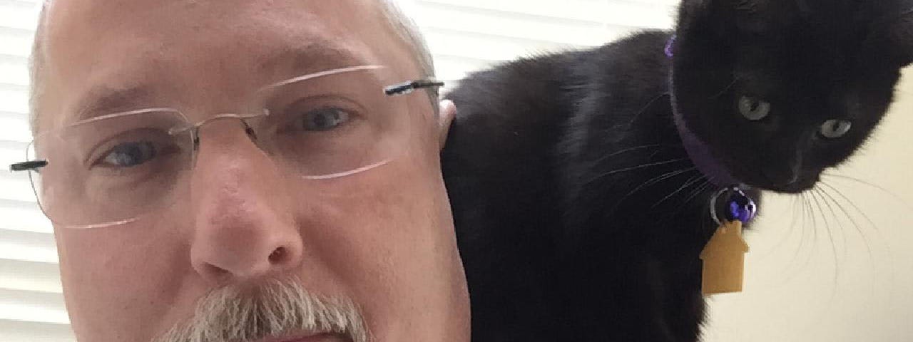 The author with his daughter’s cat pretending to be a parrot.